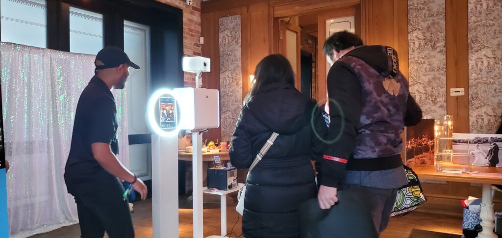 Guests having a blast and using a modern photo booth at a recent Toronto wedding open house.