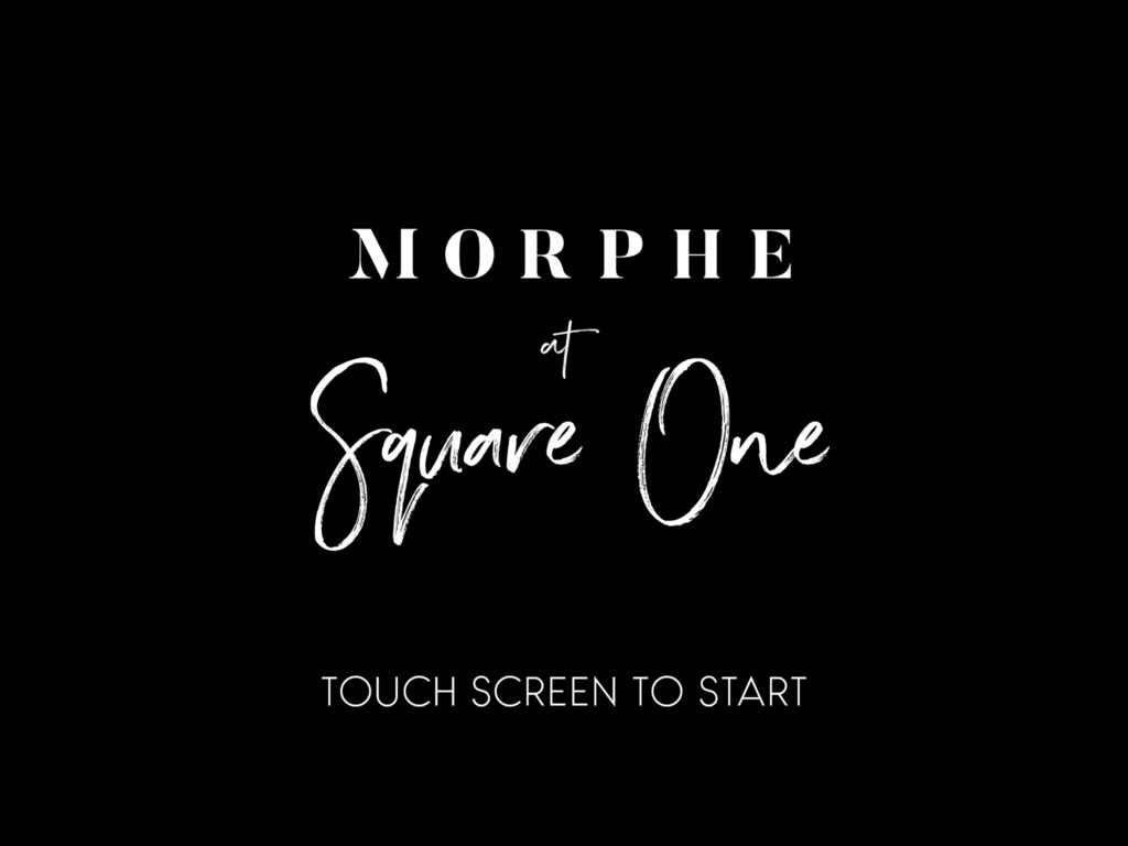 A custom branded photo booth touch screen with a black background and white text reading MORPHE at Square One and Touch Screen To Start, designed for a corporate brand activation.